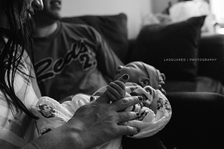newborn holding mommy's finger