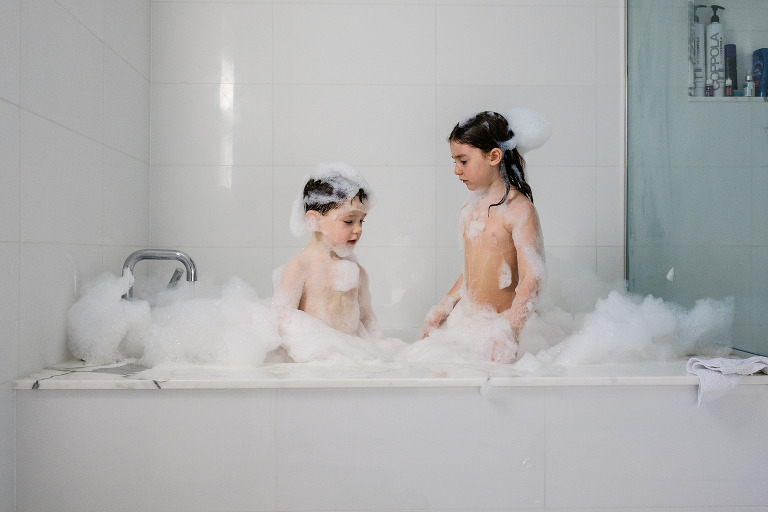 kids looking at each other in bubble bath