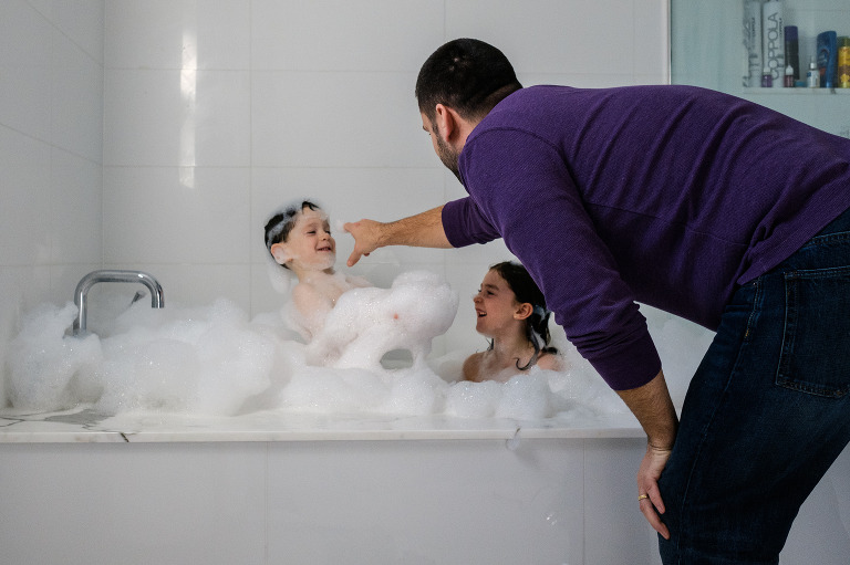 family playing in bubble bath